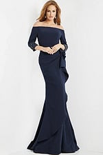 Model wearing Jovani 08699 navy off-the-shoulder gown with beadwork cuffs.