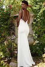 model wearing Jovani 09009 white gown with low open back