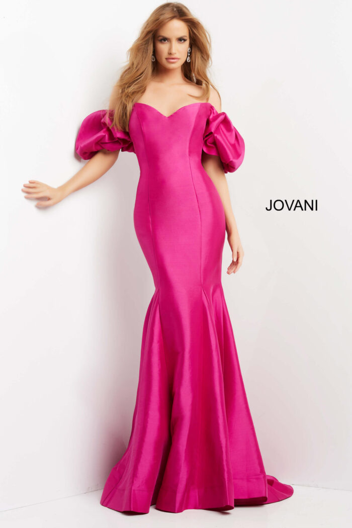 Model wearing Jovani 09031 front view of elegant pink gown with puff sleeves.