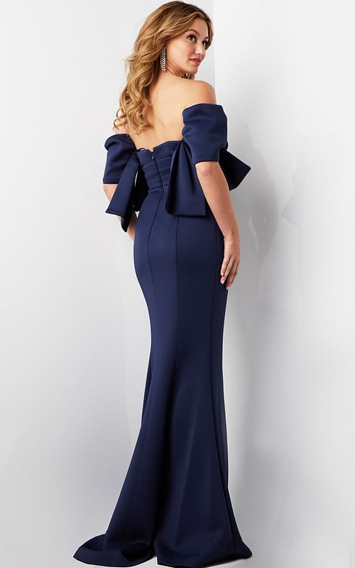 Back view of model wearing Jovani 09064 navy dress with bow accent.