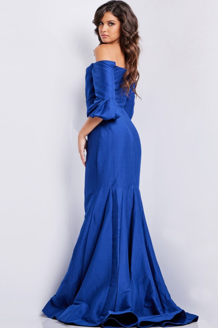 Model wearing Jovani 09420 blue dress, back view highlighting mermaid cut
