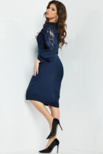 Model wearing Jovani 09471, back view of knee-length navy dress showing lace sleeve detail