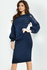 Model wearing Jovani 09471, elegant navy dress with boat neckline and lace sleeves, front view