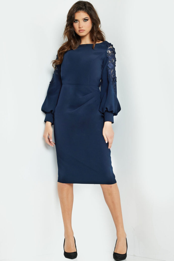 Model wearing Jovani 09471, a knee-length navy dress with balloon sleeves and boat neckline, front view