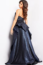 Model wearing Jovani 09481, showing the back of the royal gown with elegant draping.