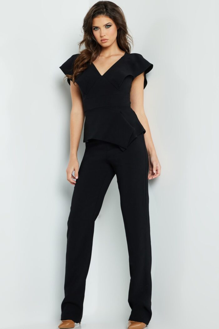 Model wearing Jovani 09646 in black, front view, full length V-neck jumpsuit.