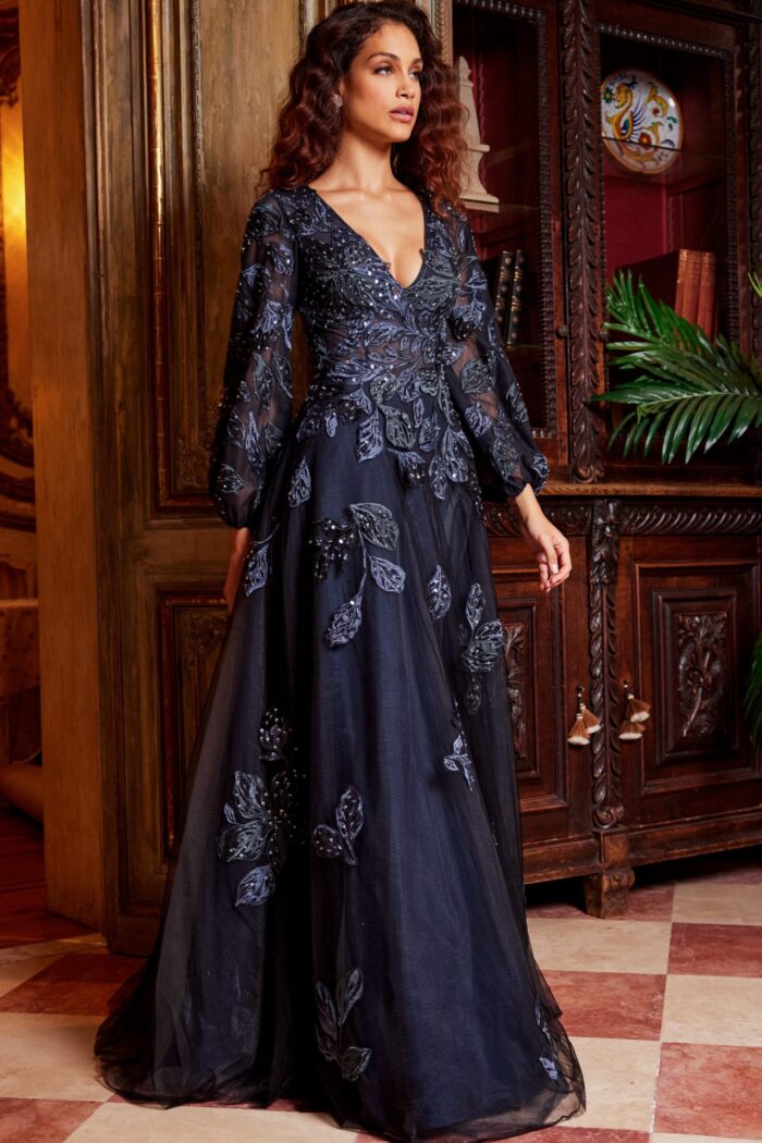 Model posing in Jovani 09943 navy gown with floral embroidery and V-neckline.
