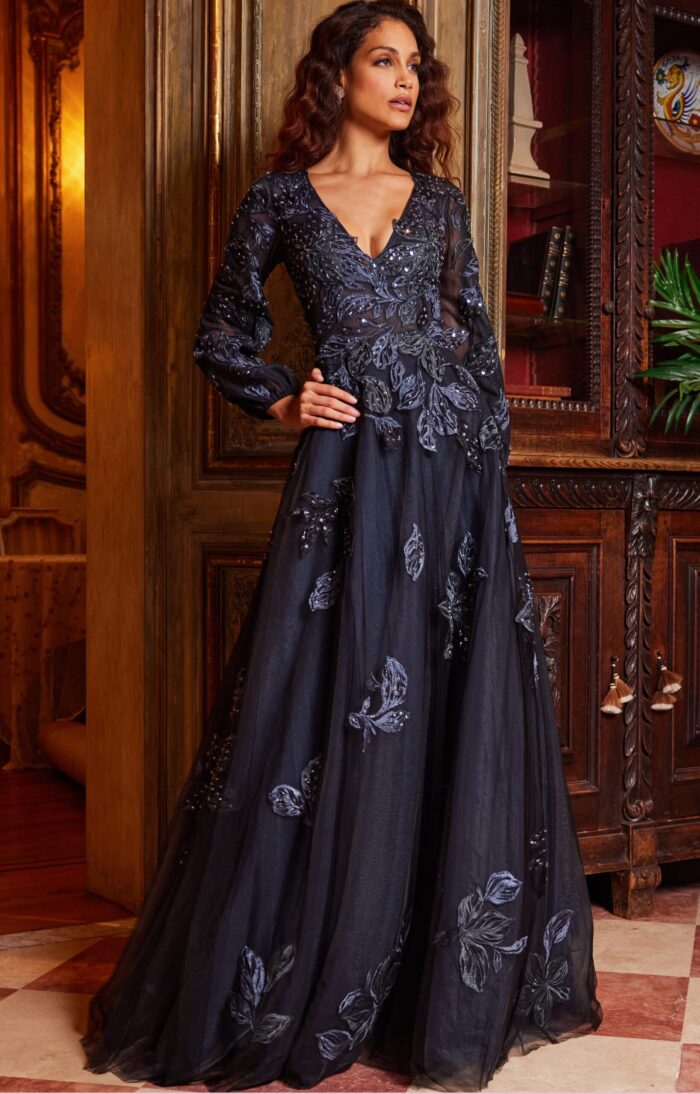 Model wearing Jovani 09943 navy gown with floral embroidery from the back.