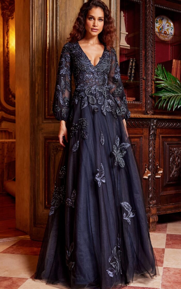 Model wearing Jovani 09943 full-length navy gown with elegant V-neckline and floral details.
