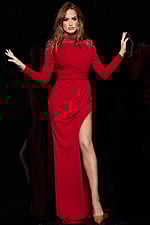 Model in Jovani 09960 red gown, showing detailed embellishments and high slit from the front.