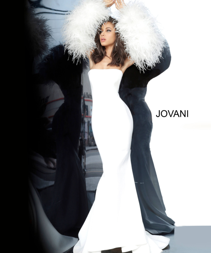 Jovani 1226 white gown with strapless design and feathered sleeves on model.