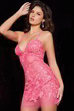Model wearing Jovani 14338 pink sequined short dress with hand on hip