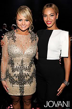 Model wearing Jovani 1349 dress at the Grammys, singing with microphone - front view.