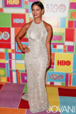 Model wearing Jovani 6657 nude gown, highlighting the fitted silhouette and details from the front.