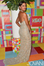Model showing the back of Jovani 6657 nude gown, highlighting the backless design.