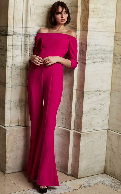Model wearing Jovani 1867 fuchsia jumpsuit with off-the-shoulder neckline