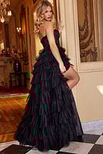 Model wearing Jovani 22226 black gown with cascading ruffles, back view.