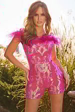 Model posing in Jovani 22349 pink mini dress with sparkling sequins and feather trim.