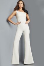 Model wearing Jovani 22589 ivory jumpsuit with asymmetrical neckline, front view.