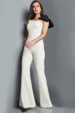 Model wearing Jovani 22589 ivory jumpsuit, front view highlighting the flared legs.