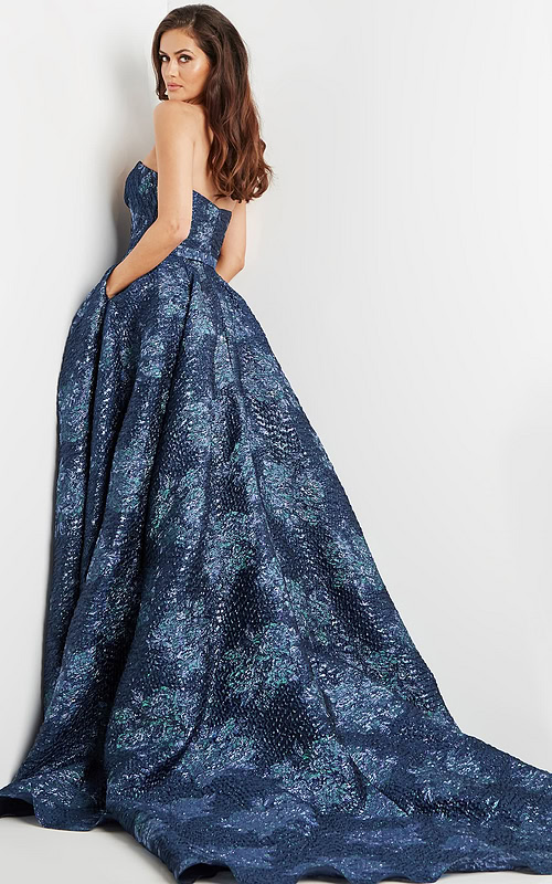 Model wearing Jovani 22792 navy gown showcasing a back view.
