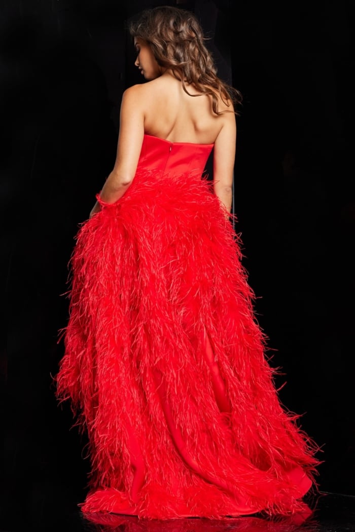 Back view of model wearing Jovani 22817 red dress with feather detailing.