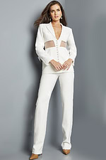 Model wearing Jovani 22818 ivory suit with V-neckline and sheer waist.