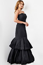 Model wearing Jovani 22921 black strapless mermaid gown, side perspective.