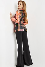 Model wearing Jovani 23002 neon orange plaid blazer dress with black trousers, back view.