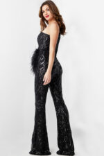 Model in Jovani 23026 black jumpsuit showcasing side view with sequin designs.