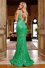 Model in Jovani 23027 green gown with a graceful back design.