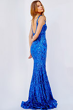 Model in Jovani 23027 royal blue dress with a mermaid silhouette, back view.