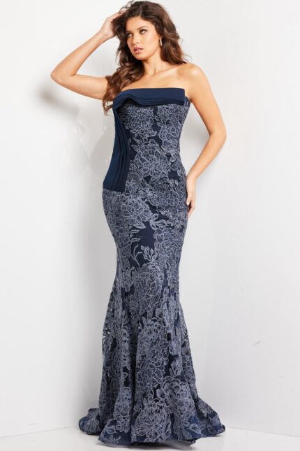 Model wearing Jovani 23031 navy strapless mermaid gown with lace detail, front view.