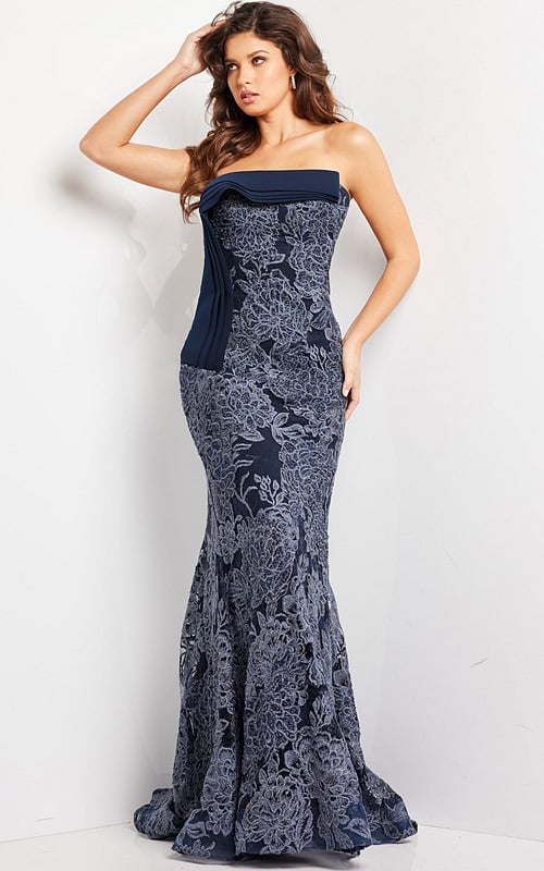 Model wearing Jovani 23031 navy strapless mermaid gown with lace detail, front view.