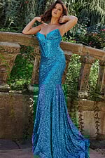 Model wearing 23077 blue sequin gown, elegant pose