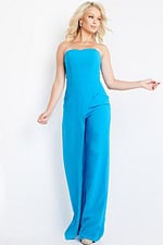 Model wearing Jovani 23082 blue strapless jumpsuit in motion.