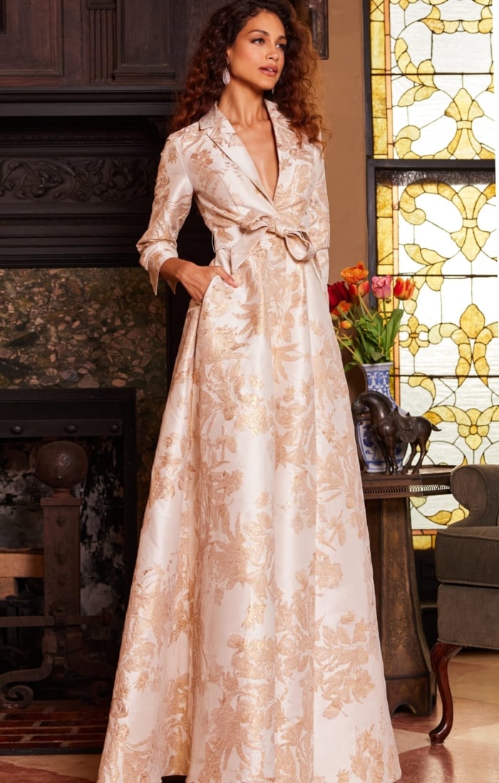 Model wearing Jovani 23178 gold floral brocade dress standing