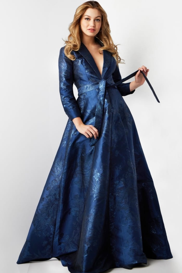 Model wearing Jovani 23178 navy floral brocade dress holding sash