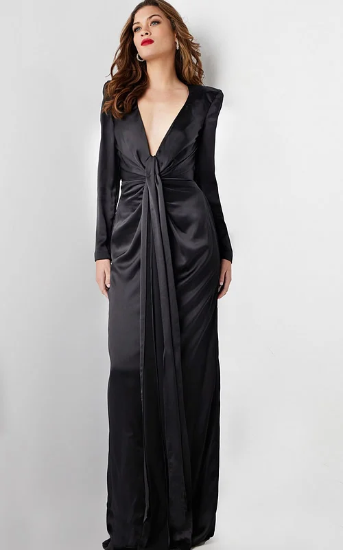 Model wearing Jovani 23180 elegant black gown with deep V-neckline and knot detail, front view.