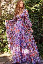 Model showcasing Jovani 23324 floral gown featuring elegant long sleeves and flowing skirt.