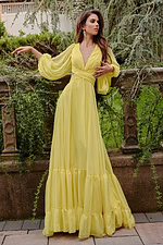 model wearing Jovani 23325 yellow gown with deep V-neck and A-line skirt
