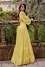 model showing back of Jovani 23325 yellow gown with open back and billowing sleeves