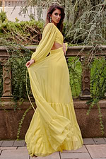 model wearing Jovani 23325 yellow A-line dress with long sleeves and side cut-out