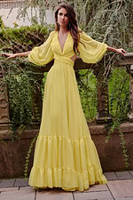 model wearing Jovani 23325 long yellow gown with V-neckline and flowing silhouette