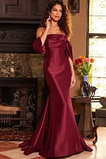 Model wearing Jovani 23398 burgundy dress, posing elegantly in front view.