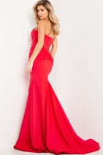 Model wearing Jovani 23556 elegant red mermaid dress, back view.