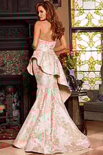 Model showcasing back of Jovani 23624 gold gown with elegant fold details