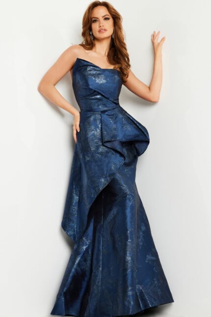 Model wearing Jovani 23624 navy gown with floral patterns and asymmetric neckline, viewed from the front.