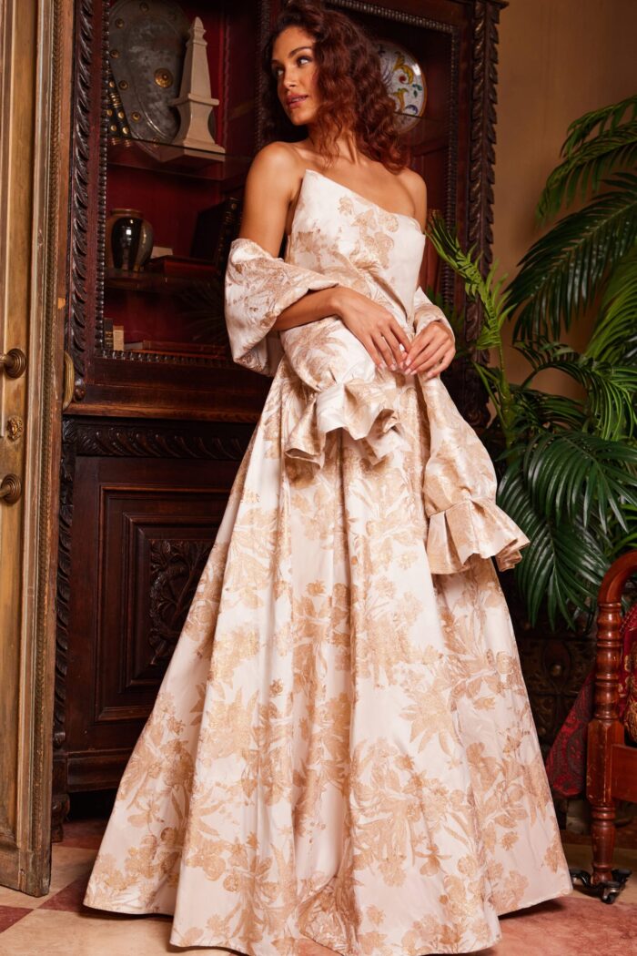 Model wearing Jovani 23625 gold gown showing the one-shoulder design, front view.