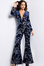 Model wearing Jovani 23708 navy jumpsuit with deep V neckline and long sleeves, showcasing elegant style.